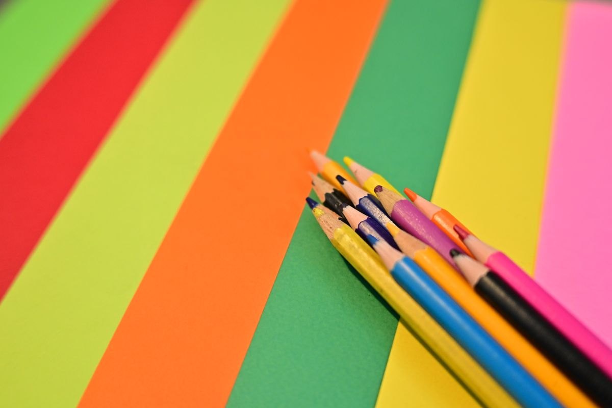 Colored pencils on bright sheets of paper.